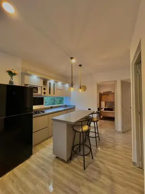 a kitchen with a table and chairs in a room at Casa N-26 Mira in Sopetran