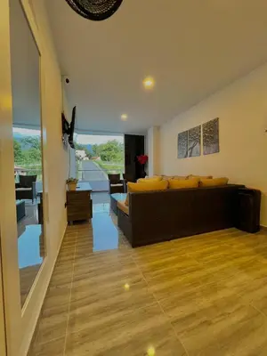 a living room with a couch and a view of a living room at Casa N-26 Mira in Sopetran