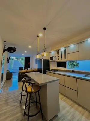 a kitchen with two bar stools and a counter top at Casa N-26 Mira in Sopetran