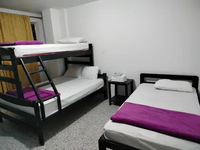 a room with two bunk beds and a chair at Hotel Galerias in Ruiosucio