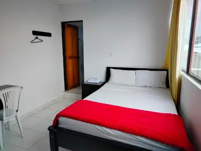 a bedroom with a bed with a red blanket at Hotel Galerias in Ruiosucio
