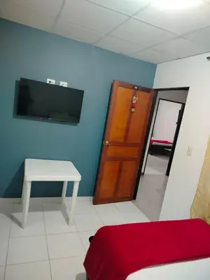 a room with a bed and a tv and a table at Hotel Galerias in Ruiosucio