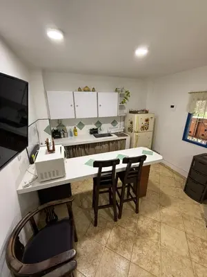 a kitchen with a table and two chairs and a counter at Encantadora finca en el corazón de Marinilla con vistas únicas y ubicación privilegiada in Marinilla
