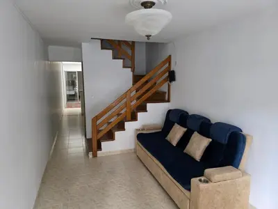 a living room with a couch and a staircase at Apartamento completo cerca del estadio in Medellín