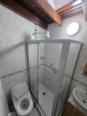 a bathroom with a toilet and a shower and a sink at Apartamento completo cerca del estadio in Medellín