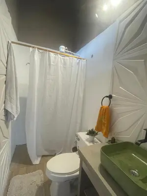 a bathroom with a white toilet and a sink at Casa de Campo Cerca a Medellín in Angelópolis