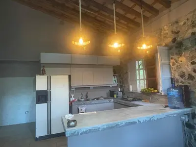 a kitchen with a white refrigerator and some lights at Casa de Campo Cerca a Medellín in Angelópolis