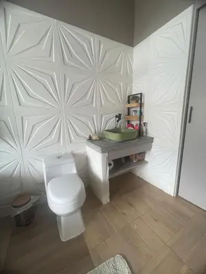 a bathroom with a white toilet and a sink at Casa de Campo Cerca a Medellín in Angelópolis