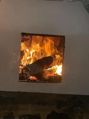 a fire in a brick oven with a carrot in it at Casa de Campo Cerca a Medellín in Angelópolis