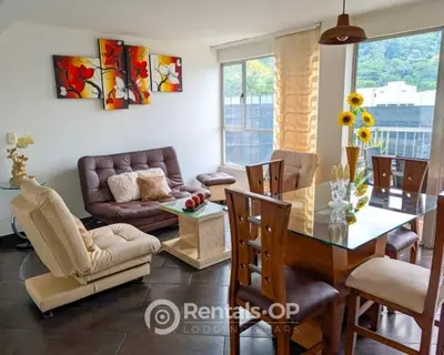a living room with a table and a couch at Spacious apartment near Lleras and Provenza rentalsOP AN08 in Medellín