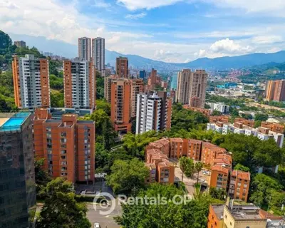 a view of a city with tall buildings and trees at Spacious apartment near Lleras and Provenza rentalsOP AN08 in Medellín