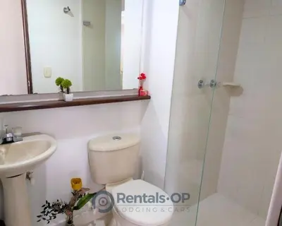 a bathroom with a toilet and a sink and a shower at Spacious apartment near Lleras and Provenza rentalsOP AN08 in Medellín