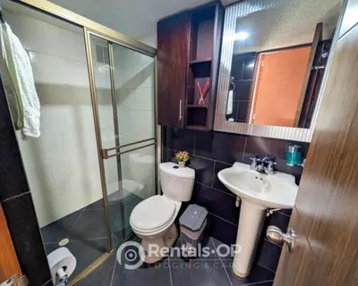 a bathroom with a toilet and a sink and a shower at Spacious apartment near Lleras and Provenza rentalsOP AN08 in Medellín