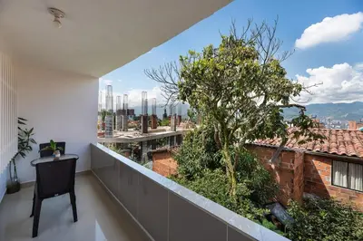 a balcony with a table and a view of a city at Spacious House with Garden & View over Medellin in Medellín