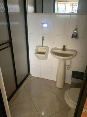 a bathroom with a sink and a toilet at Finca Panoramica in Barbosa