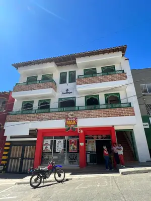 a building with a motorcycle parked in front of it at Candilejas in Fredonia