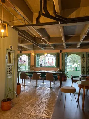 a room with a pool table and chairs and windows at Candilejas in Fredonia