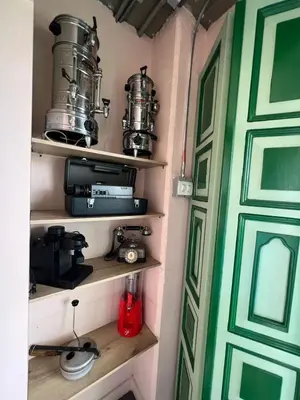 a room with shelves with pots and pans and a door at Candilejas in Fredonia