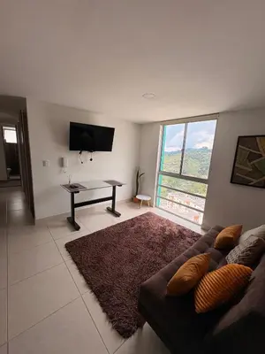 a living room with a couch and a table at Apartamento Urban Manizales Acogedor in Manizales