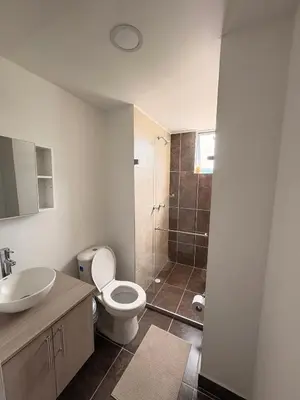 a bathroom with a toilet and a sink and a shower at Apartamento Urban Manizales Acogedor in Manizales