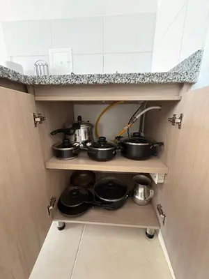 a bunch of pots and pans on a shelf in a kitchen at Apartamento Urban Manizales Acogedor in Manizales
