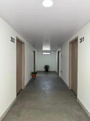 an empty hallway in an office building with doors and plants at Casa Bosque Vivo in Norcasia