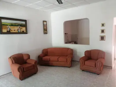 a waiting room with two chairs and a mirror at Casa Zona Rosa in La Dorada