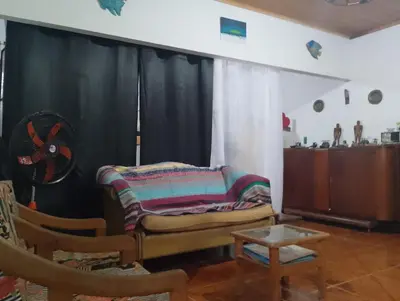 a living room with a couch and a fan at Casa Sol y Río in Honda