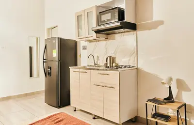 a kitchen with a refrigerator and a sink at Apartamento A108 en el Poblado in Medellín