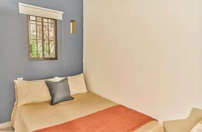 a bedroom with a bed and a window at Apartamento A108 en el Poblado in Medellín