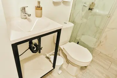 a bathroom with a toilet and a sink and a shower at Apartamento A108 en el Poblado in Medellín
