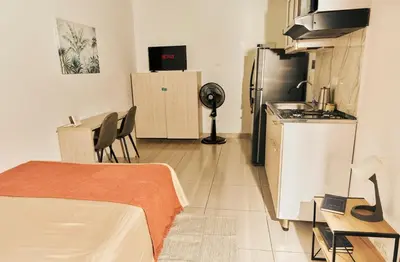 a small room with a kitchen and a refrigerator at Apartamento A108 en el Poblado in Medellín