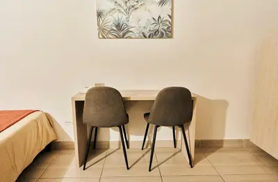 two chairs sitting at a desk in a bedroom at Apartamento A108 en el Poblado in Medellín