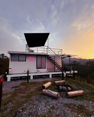 a house on top of a hill with a fire place at Glamping La Maestranza con desayuno incluido in Estación El Salto