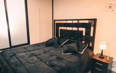 a bedroom with a large bed with pillows on it at Glamping La Maestranza con desayuno incluido in Estación El Salto
