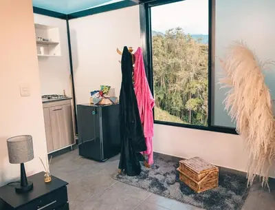 a room with a large window with a dress on display at Glamping La Maestranza con desayuno incluido in Estación El Salto