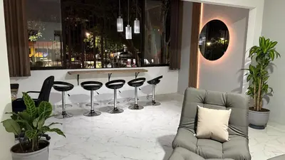 a living room with a bar with stools at Medellin La 70 - Laureles in Medellín