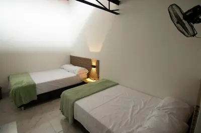 two beds in a small room with at Medellin La 70 - Laureles in Medellín