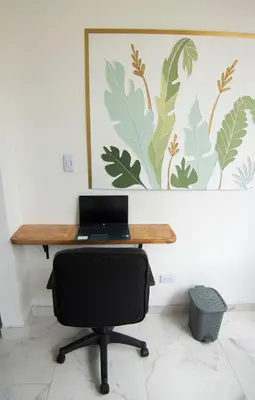 a desk with a laptop computer on top of it at Medellin La 70 - Laureles in Medellín