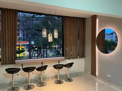 a bar with stools in front of a window at Medellin La 70 - Laureles in Medellín