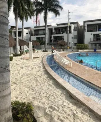 a resort with a swimming pool and palm trees at Apartasol por días en condominio ciudadela Santa Fe de Antioquia in Santa Fe de Antioquia