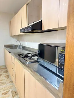 a kitchen with a stove and a microwave at Unbeatable location in Medellín in Medellín