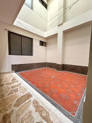 an empty room with a red tile floor and a window at Unbeatable location in Medellín in Medellín