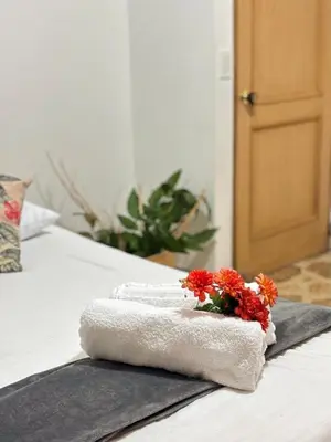 a pile of towels and flowers on a bed at Unbeatable location in Medellín in Medellín