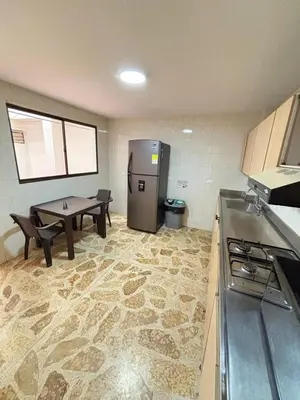 a kitchen with a refrigerator and a table in it at Unbeatable location in Medellín in Medellín