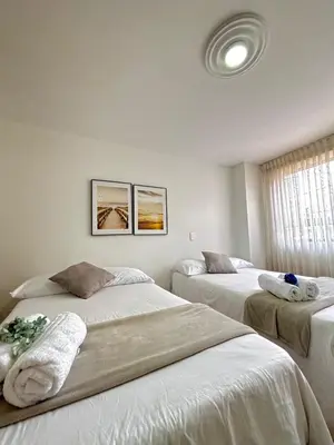 a bedroom with two beds with towels on them at Unbeatable location in Medellín in Medellín