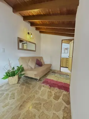 a living room with a couch and a rug at Confort y Estilo en el Centro de Medellín Perfecto para tu Estancia in Medellín