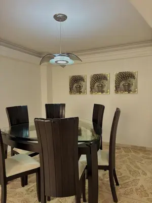a dining room with a glass table and chairs at Confort y Estilo en el Centro de Medellín Perfecto para tu Estancia in Medellín