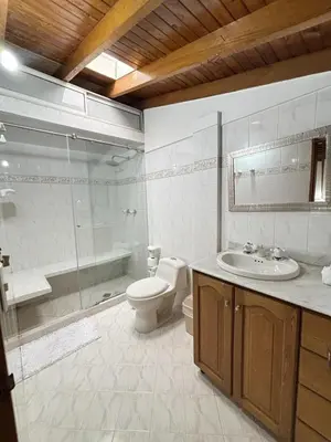 a bathroom with a toilet and a sink and a shower at Confort y Estilo en el Centro de Medellín Perfecto para tu Estancia in Medellín