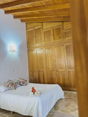 a bedroom with a bed with wooden cabinets at Confort y Estilo en el Centro de Medellín Perfecto para tu Estancia in Medellín
